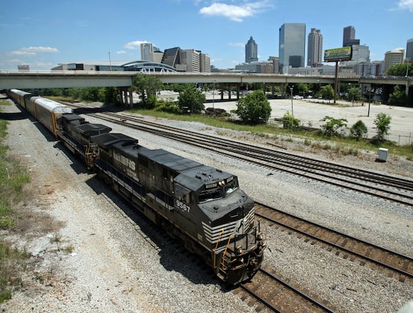 A Norfolk-Southern train travels near the Mitchell Street bridge in the downtown Atlanta’s Gulch.  JASON GETZ / JGETZ@AJC.COM