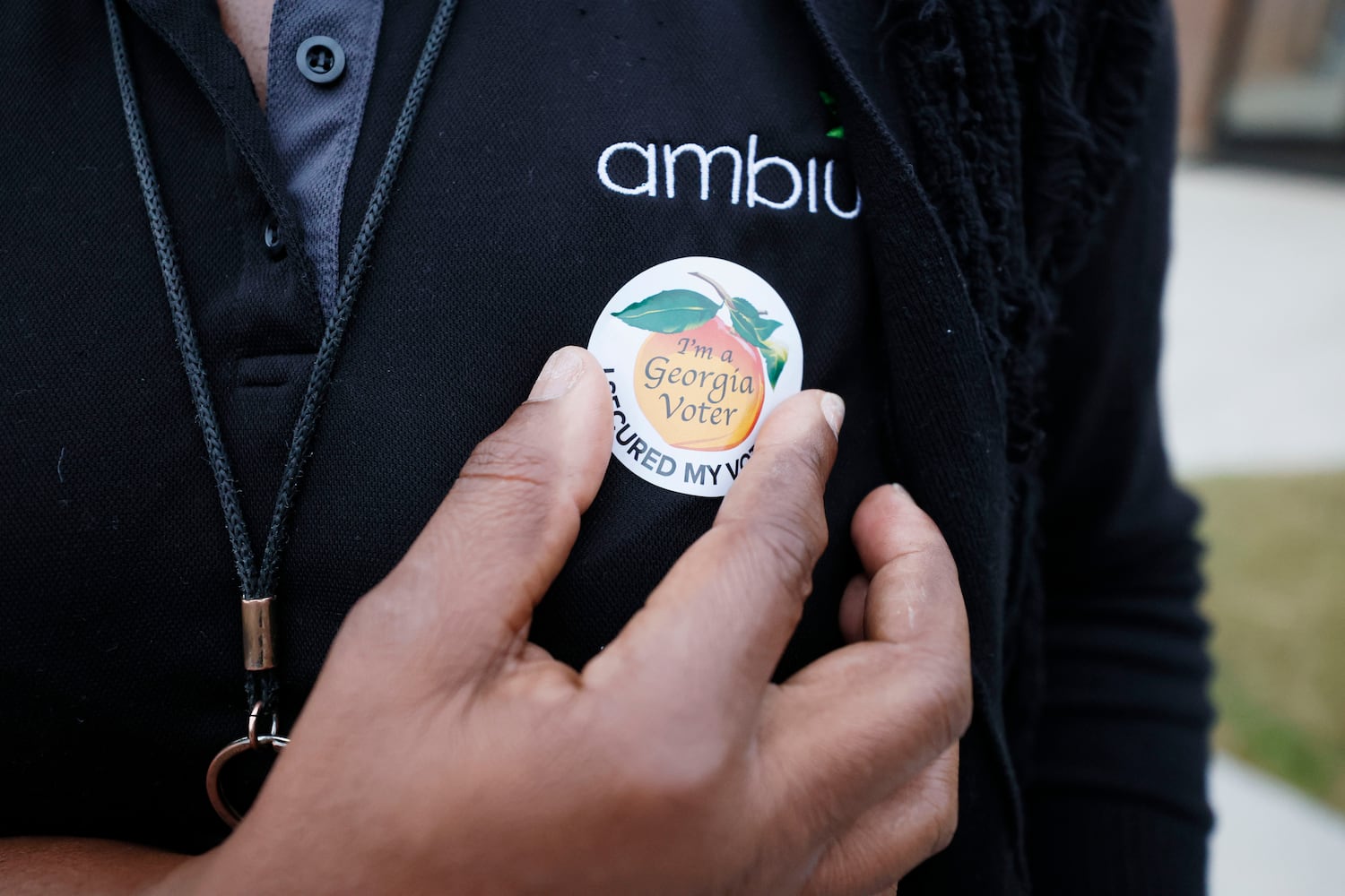 Latonya Williamson puts her Georgia voter sticker after casting her ballot at the Berean Christian Church in Stone mountain during the first day of early voting of the general elections on Monday, October 17, 2022. Miguel Martinez / miguel.martinezjimenez@ajc.com