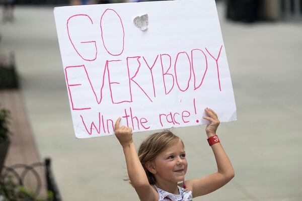 Vera Holmes cheers on runners during the AJC Peachtree Road Race in Atlanta, Thursday, July 4, 2019. (Alyssa Pointer/alyssa.pointer@ajc.com)