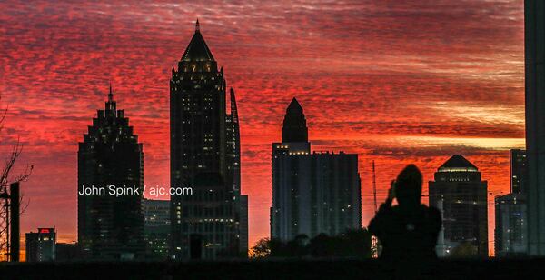 Rosa Mendez, a support teacher at the Howard School, takes a picture of Thursday’s sunrise in the 1100 block of Howell Mill. While the day started out chilly, Thursday should end feeling more like early spring, according to Channel 2 Action News.