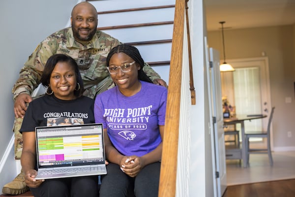 Liberty County High School graduate Madison Crowell, right, poses with her mother and father, Melissa and Delando Langley, showing a spreadsheet with her college scholarship offers on Wednesday, May 29, 2024 in Hinesville, Georgia. (AJC Photo/Stephen B. Morton)