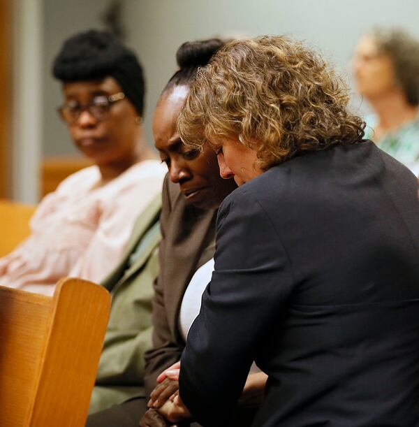 April 24, 2019 - Lawrenceville -  Lisa Neal (right), who was Emani Moss' elementary school teacher, gives Robin Moss, Emani's grandmother, a hug after Neal testified during Day One of the Tiffany Moss death penalty trial. Tiffany Moss is accused of starving her  stepdaughter Emani, and then trying to burn the corpse.     