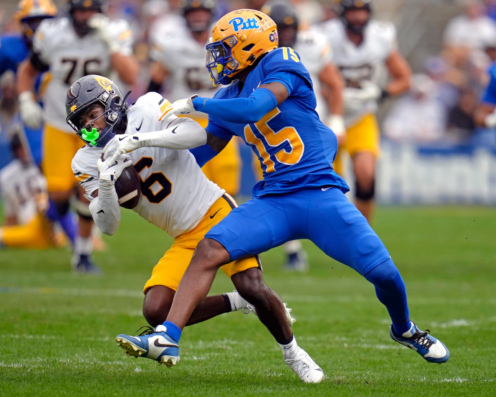 California wide receiver Jonathan Brady (6) is tackled, after making a catch for a first down, by Pittsburgh defensive back Rashad Battle (15), during the first half of an NCAA college football game Saturday, Oct. 12, 2024, in Pittsburgh. (AP Photo/Gene J. Puskar)