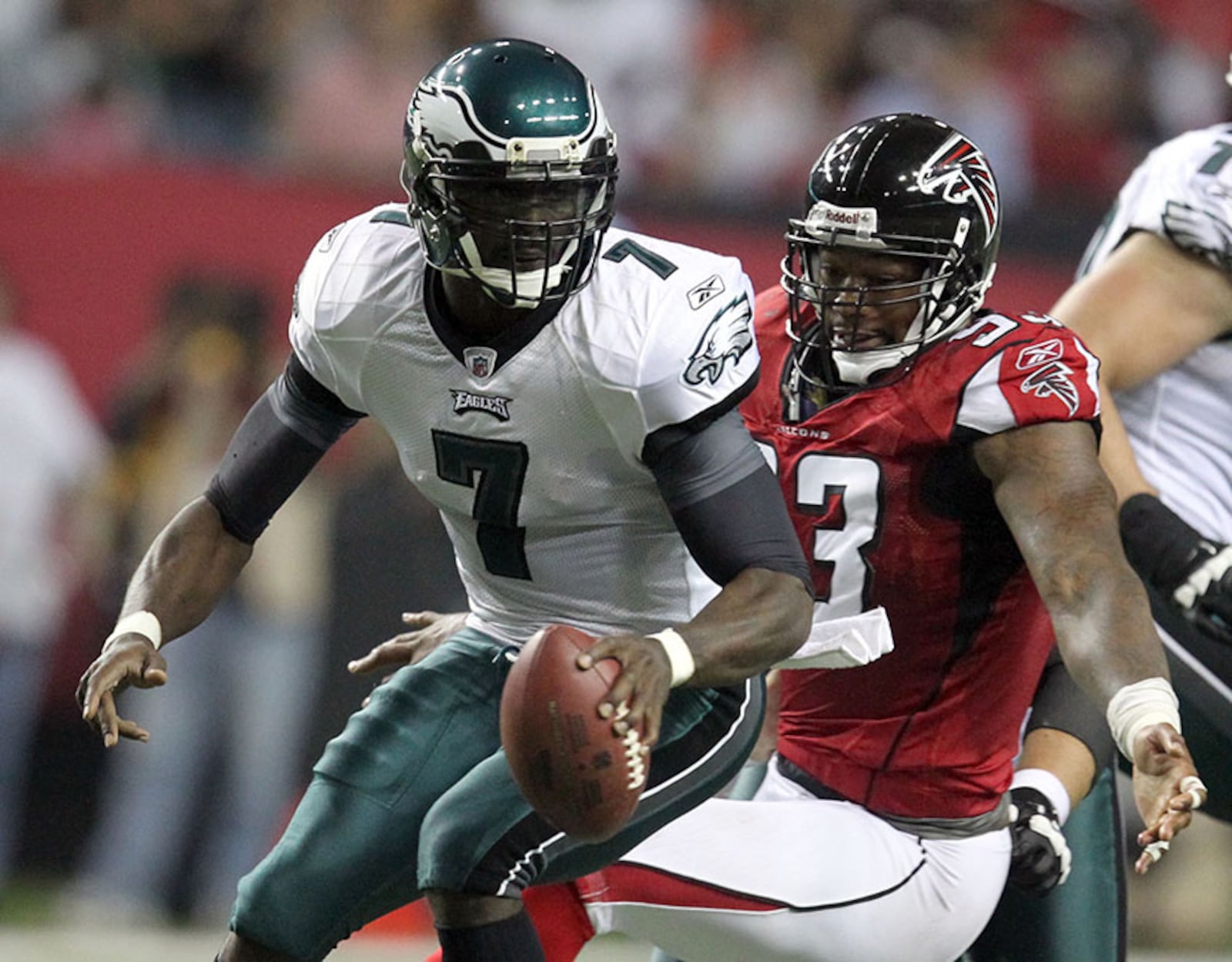 Philadelphia Eagles quarterback Michael Vick (7) elludes the pressure by Atlanta Falcons defensive end Ray Edwards Sept. 18, 2011, at the Georgia Dome in Atlanta.