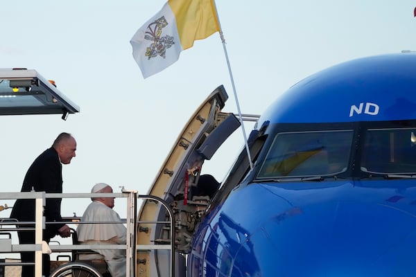 Pope Francis boards an airplane at Rome's Fiumicino, airport as he leaves for his one-day visit to Ajaccio in he French island of Corsica, Sunday, Dec.15, 2024. (AP Photo/Gregorio Borgia)