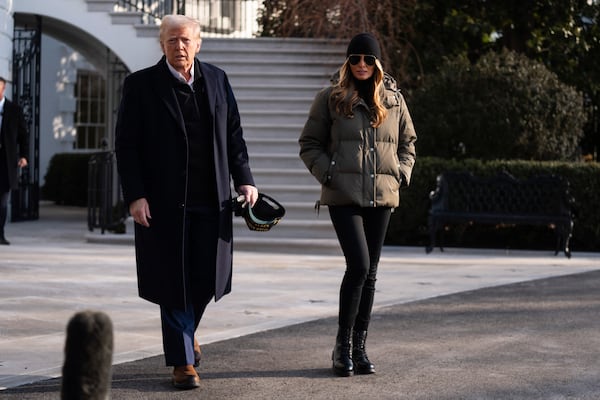 First lady Melania Trump and President Donald Trump walk over to speak with reporters before boarding Marine One on the South Lawn of the White House, Friday, Jan. 24, 2025, in Washington. (AP Photo/Evan Vucci)