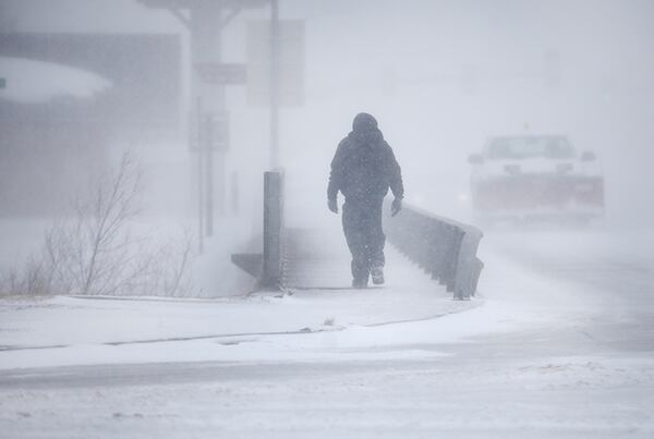 A man crosses over a creek during a blizzard on March 13, in Cheyenne, Wyoming, as a "bomb cyclone" hit the United States.