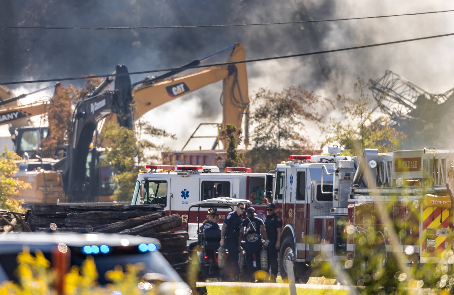 BioLab was still smoldering at mid-morning Wednesday, Oct 2, 2024 as a large mile-long plume was still visible over Conyers as crews worked at the plant that caught on fire days earlier. But as the sun lifted above the horizon, so did the shelter-in-place order for Rockdale County residents. Those living nearby have been advised to stay inside every evening through early morning until Friday. (John Spink/AJC)