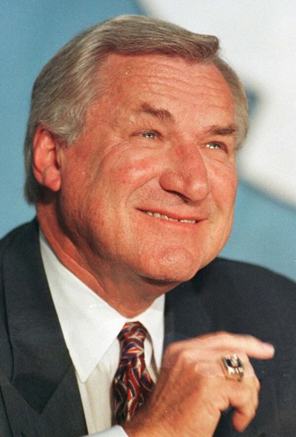 FILE - In an Oct. 9, 1997 file photo, North Carolina basketball coach Dean Smith smiles during a news conference in Chapel Hill, N.C.,where he announced his retirement. Smith, the North Carolina basketball coaching great who won two national championships, died "peacefully" at his home Saturday night, Feb. 7, 2015, the school said in a statement Sunday from Smith's family. He was 83. (AP Photo/Bob Jordan, File) Dean Smith announcing his retirement in 1997. (Bob Jordan/AP photo)