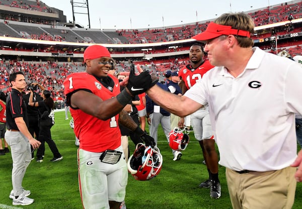 Georgia running back Trevor Etienne (1) is congratulated by Georgia head coach Kirby Smart after Georgia beat Auburn in an NCAA football game at Sanford Stadium, Saturday, October 5, 2024, in Athens. Georgia won 31-13 over Auburn. (Hyosub Shin / AJC)