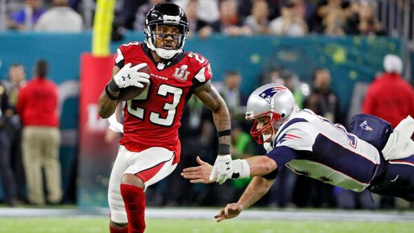 Falcons cornerback Robert Alford sprints to the end zone past Patriots quarterback Tom Brady on an 82-yard interception return in the Super Bowl Sunday, Feb. 5, 2017, at NRG Stadium in Houston.