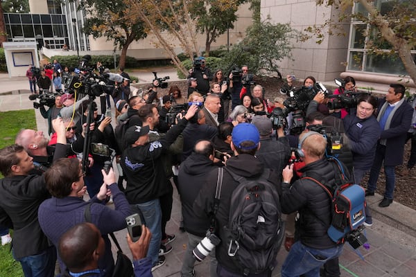 The media surround family members of the Erik and Lyle Menendez brothers as they arrive at a courthouse to attend a hearing in Los Angeles, Monday, Nov. 25, 2024. (AP Photo/Jae C. Hong)