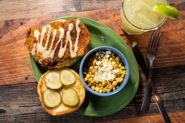  Parker's Chicken Sandwich with house-smoked chicken, Parker's pickles, Alabama white bbq sauce on a potato bun, with a side of roasted cream corn, and an Alligator Rita cocktail. Photo credit- Mia Yakel.