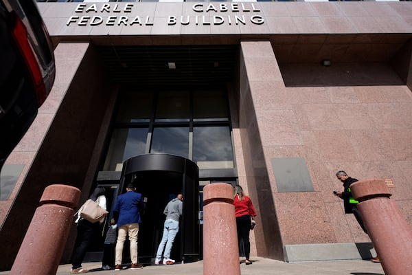 People enter the Earle Cabell Federal Building in downtown Dallas, Monday, Feb. 24, 2025. (AP Photo/LM Otero)