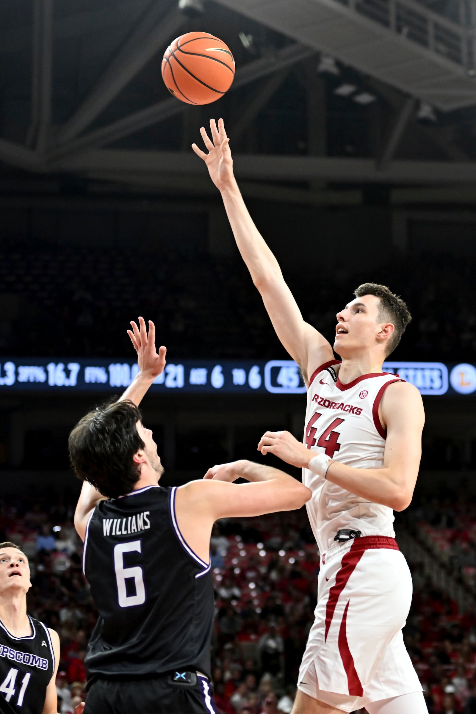 Arkansas forward Zvonimir Ivisic (44) shoots over Lipscomb center Charlie Williams (6) during the second half of an NCAA college basketball game Wednesday, Nov. 6, 2024, in Fayetteville, Ark. (AP Photo/Michael Woods)