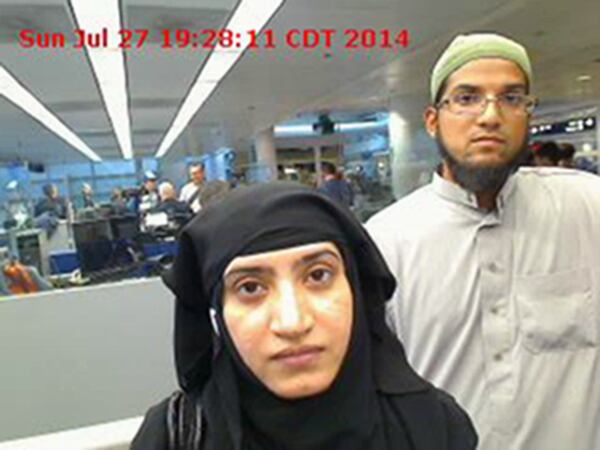 This July 27, 2014, photo provided by U.S. Customs and Border Protection shows Tashfeen Malik, left, and Syed Farook, as they passed through O'Hare International Airport in Chicago. A U.S. magistrate has ordered Apple to help the Obama administration hack into an iPhone belonging to one of the shooters in San Bernardino, Calif. The ruling by Sheri Pym on Feb. 16, 2016, requires Apple to supply highly specialized software the FBI can load onto the phone to cripple a security encryption feature that erases data after too many unsuccessful unlocking attempts. Federal prosecutors told the judge they can't access a county-owned work phone used by Farook because they don't know his passcode. (U.S. Customs and Border Protection via AP)