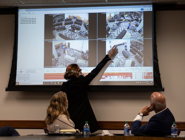 201203-Atlanta- Jacki Pick points out what she considered suspicious activity on surveillance video of the Fulton County absentee vote counting room as she and Rudy Giuliani address a subcommittee of the state Senate judiciary committee at the State Capitol on Thursday, Dec. 3, 2020. Ben Gray for the Atlanta Journal-Constitution