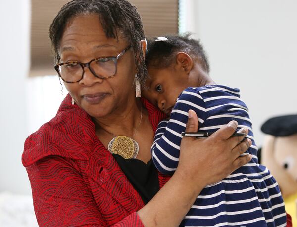 Wanda Irving holds Soleil Irving, 2, in their home in Sandy Springs.