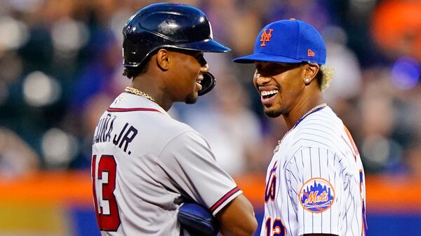 Braves outfielder Ronald Acuna (13) and New York Mets shortstop Francisco Lindor (12) chat during a pause in action in the second game of a doubleheader, Monday, June 21, 2021, in New York. (Kathy Willens/AP)