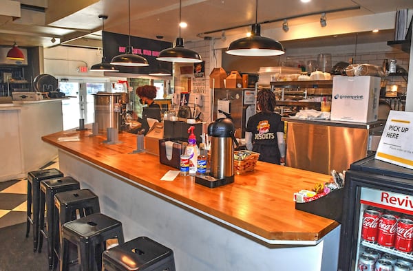 A few counter stools offer a front row seat to the biscuit baking and sandwich assembly. Chris Hunt for The Atlanta Journal-Constitution