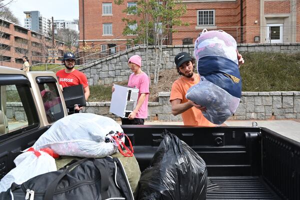 Georgia Tech student Zach Ellison (right) loads a truck as he prepares to move out from his dormitory on Georgia Tech campus on Saturday, March 14, 2020. HYOSUB SHIN / HYOSUB.SHIN@AJC.COM