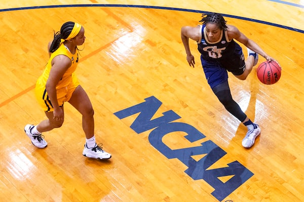 Georgia Tech guard Kierra Fletcher (41) drives around West Virginia guard Kirsten Deans during the first half of a college basketball game in the second round of the NCAA women's tournament at the Convocation Center in San Antonio on Tuesday, March 23, 2021. (AP Photo/Stephen Spillman)