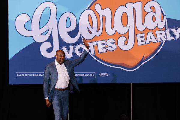 U.S. Sen. Raphael Warnock walks onto stage at a voting rally for Democrats in Atlanta on Oct. 28, 2022. Former President Barack Obama also attended the rally. (Arvin Temkar / arvin.temkar@ajc.com)