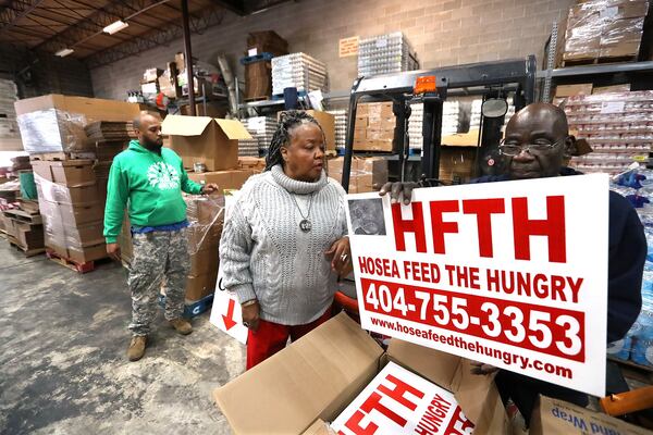 Hosea Williams III (from left), Hosea Feed the Hungry CEO Elisabeth Omilami, and Hopeton Gordon work at a rental warehouse while renovations were being made to the organization's existing location on Thursday, Jan. 16, 2020, in Atlanta. (Curtis Compton / ccompton@ajc.com)