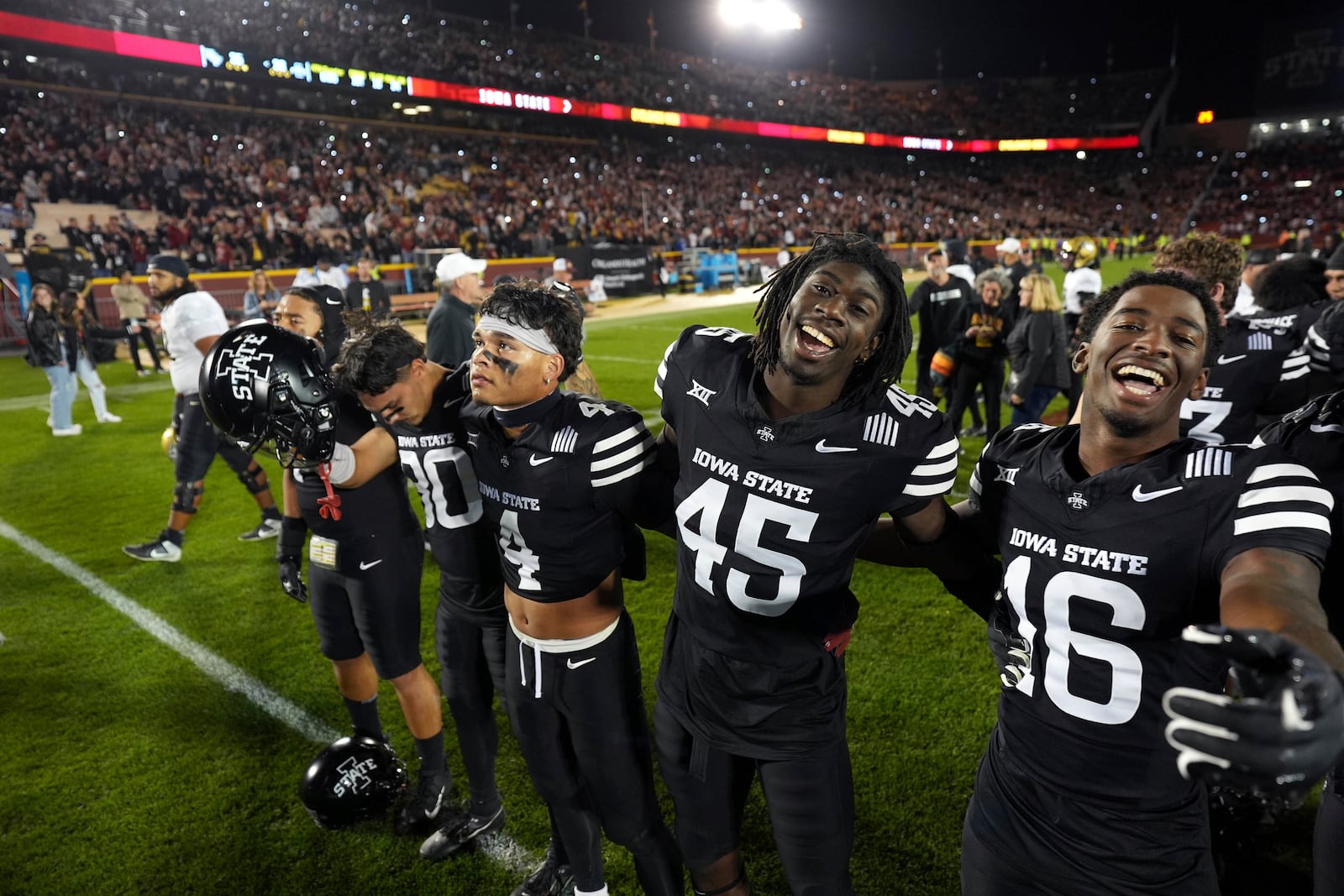 Iowa State's Jonathan Vande Walle (80), Jeremiah Cooper (4), Samuel Same (45), and Matthew Bess (16) celebrate Iowa State's 38-35 victory over Central Florida during an NCAA college football game, Saturday, Oct. 19, 2024, in Ames, Iowa. AP Photo/Matthew Putney)