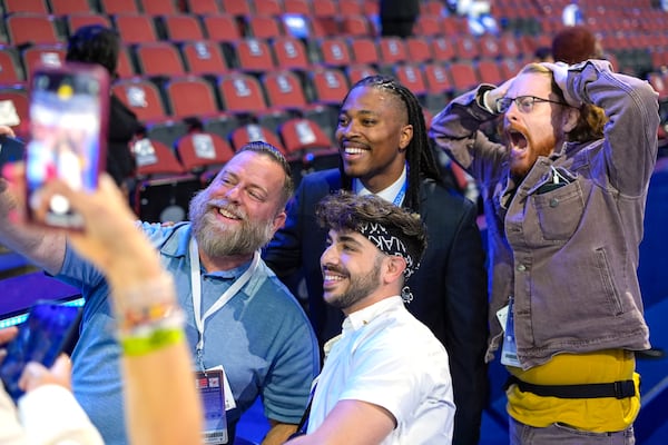 FILE - Malcolm Kenyatta, center, a member of the Pennsylvania House of Representatives, poses with DNC content creators Kory Aversa, from left, Johnny Palmadessa and Alexander Pearlman at the Democratic National Convention, Aug. 22, 2024, in Chicago. (AP Photo/Pablo Martinez Monsivais, File)