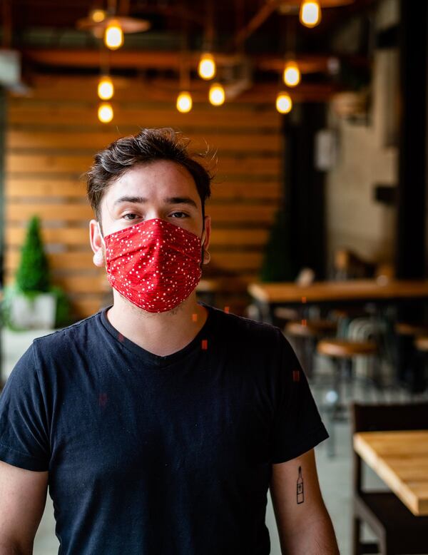 Christian Martinez, a server at Forza Storico, has taken on additional responsibilities during the pandemic. CONTRIBUTED BY HENRI HOLLIS