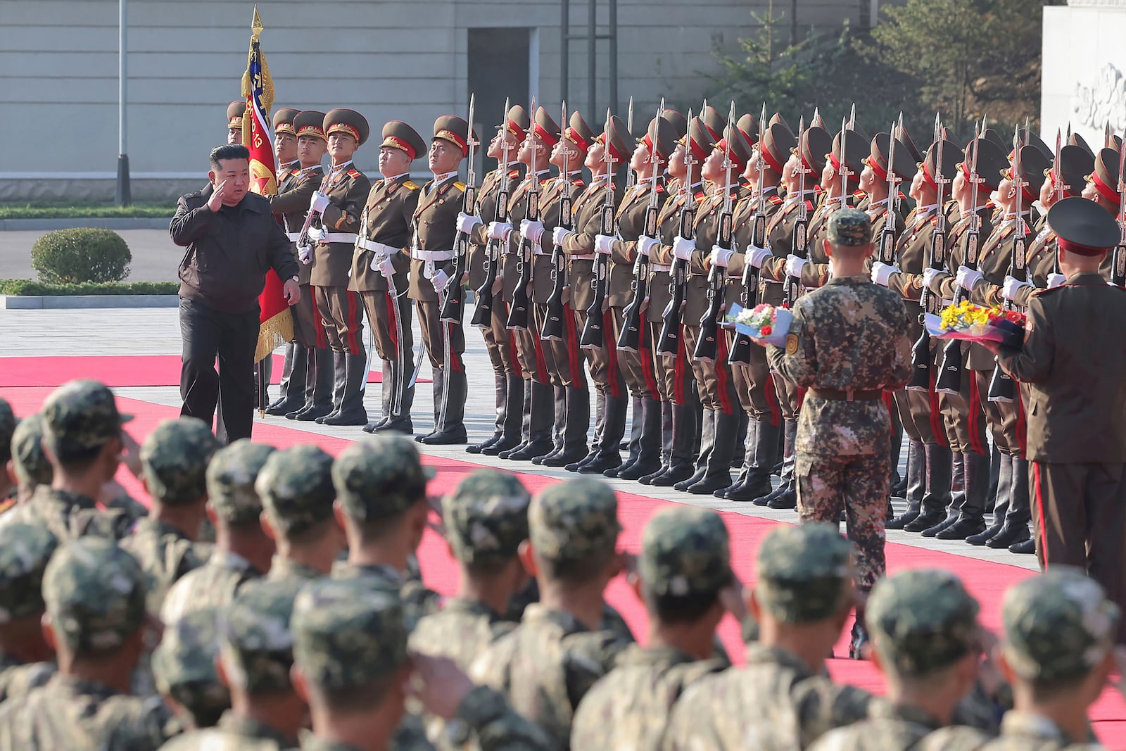 In this photo provided by the North Korean government, North Korean leader Kim Jong Un, left on red carpet, visits the headquarters of the North Korean People’s Army’s 2nd Corps at an undisclosed place in North Korea Thursday, Oct. 17, 2024. Independent journalists were not given access to cover the event depicted in this image distributed by the North Korean government. The content of this image is as provided and cannot be independently verified. (Korean Central News Agency/Korea News Service via AP)