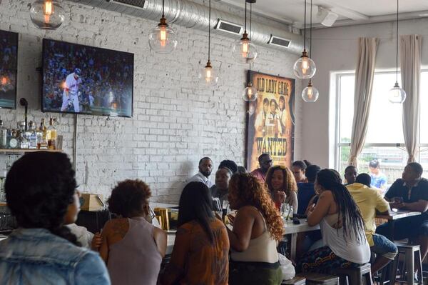  The bar area at Old Lady Gang features large windows and some family-style seating. CONTRIBUTED BY HENRI HOLLIS