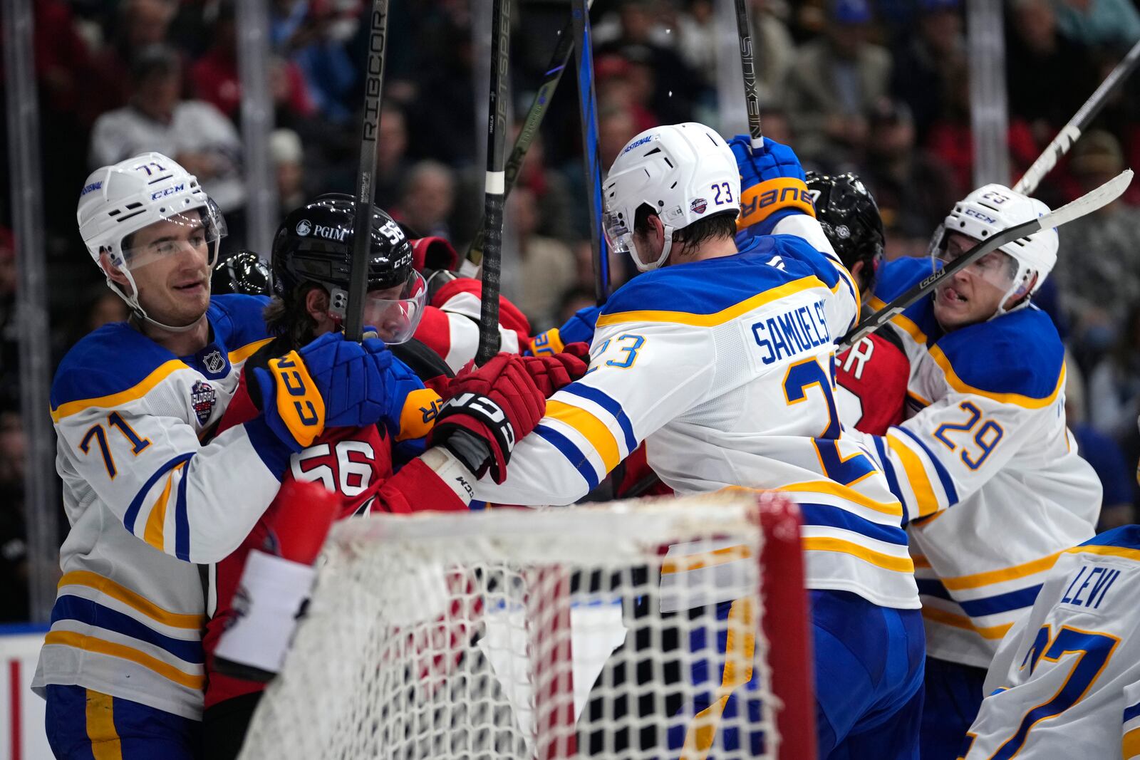 Players scuffle during the NHL hockey game between Buffalo Sabres and New Jersey Devils, in Prague, Czech Republic, Saturday, Oct. 5, 2024. (AP Photo/Petr David Josek)