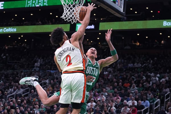 Boston Celtics guard Jordan Walsh (27) is fouled by Detroit Pistons guard Cade Cunningham (2) during the first half of an NBA basketball game, Wednesday, Dec. 4, 2024, in Boston. (AP Photo/Charles Krupa)