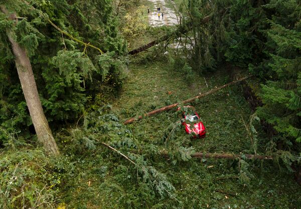 A car sits abandoned as several downed trees block a street after severe weather hit the area on Wednesday, Sept. 20, 2024, in Bellevue, Wash. (Nick Wagner/The Seattle Times via AP)