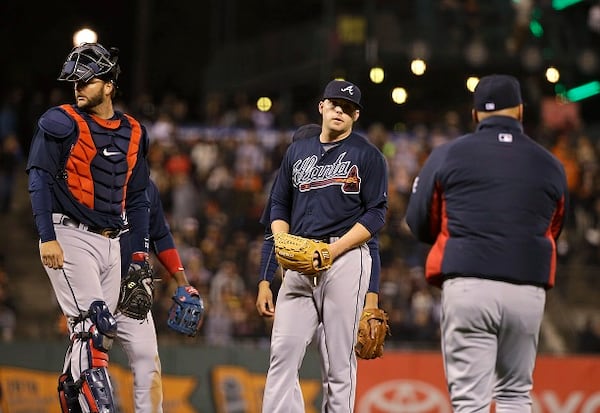 Atlanta Braves relief pitcher Brandon Cunniff, center, stands on the mound as manager Fredi Gonzalez, right, comes out to remove him during the eighth inning of the Braves' baseball game against the San Francisco Giants on Thursday, May 28, 2015, in San Francisco. At left is catcher A.J. Pierzynski. (AP Photo/Eric Risberg)