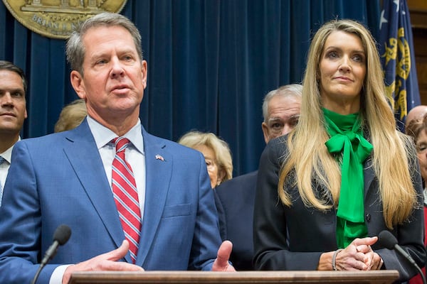 12/04/2019 -- Atlanta, Georgia -- Newly appointed U.S. Senator Kelly Loeffler (right) listens as Georgia Gov. Brian Kemp (left) speaks during a press conference in his office at the Georgia State Capitol Building, Wednesday, December 4, 2019. Georgia Gov. Brian Kemp appointed Kelly Loeffler to the U.S. Senate to take the place of U.S. Senator Johnny Isakson, who is stepping down for health reasons.