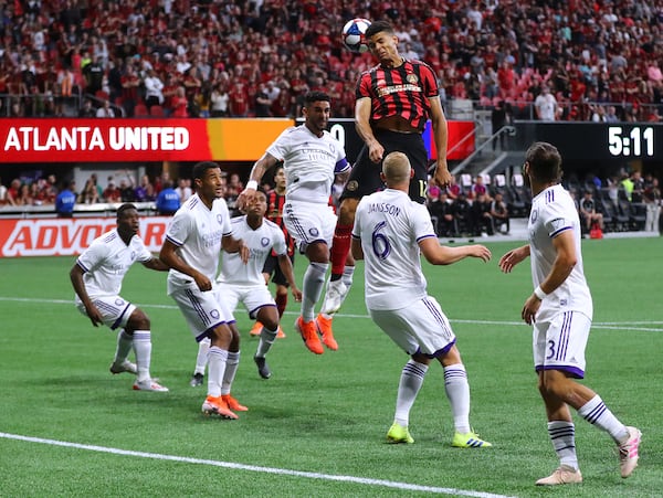 Atlanta United defender Miles Robinson trys to head a corner kick into the net against a host of Orlando City defenders Sunday, May 12, 2019, in Atlanta.  