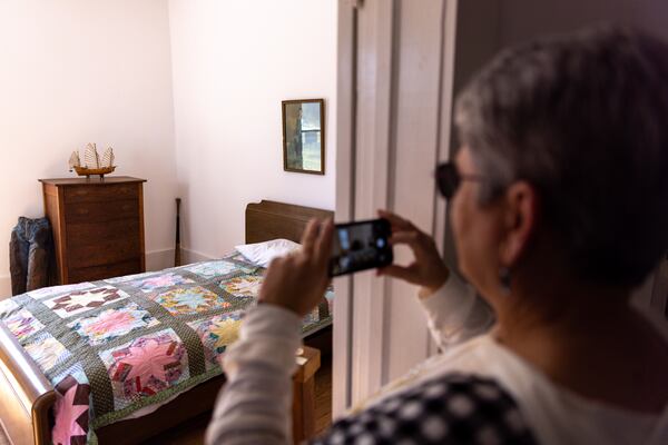 A tourist takes a photo of Jimmy Carter’s boyhood bedroom. (Arvin Temkar / arvin.temkar@ajc.com)