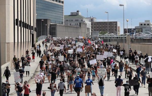 May 29, 2020 — Atlanta — After a peaceful march the Georgia State Capitol that swelled into the hundreds, protestors returned to the area around the Centennial Olympic Park and CNN center where some confronted police, who sprayed some demonstrators with pepper spray. They carried signs and chanted their messages of outrage over the death of George Floyd in Minneapolis. ALYSSA POINTER / ALYSSA.POINTER@AJC.COM