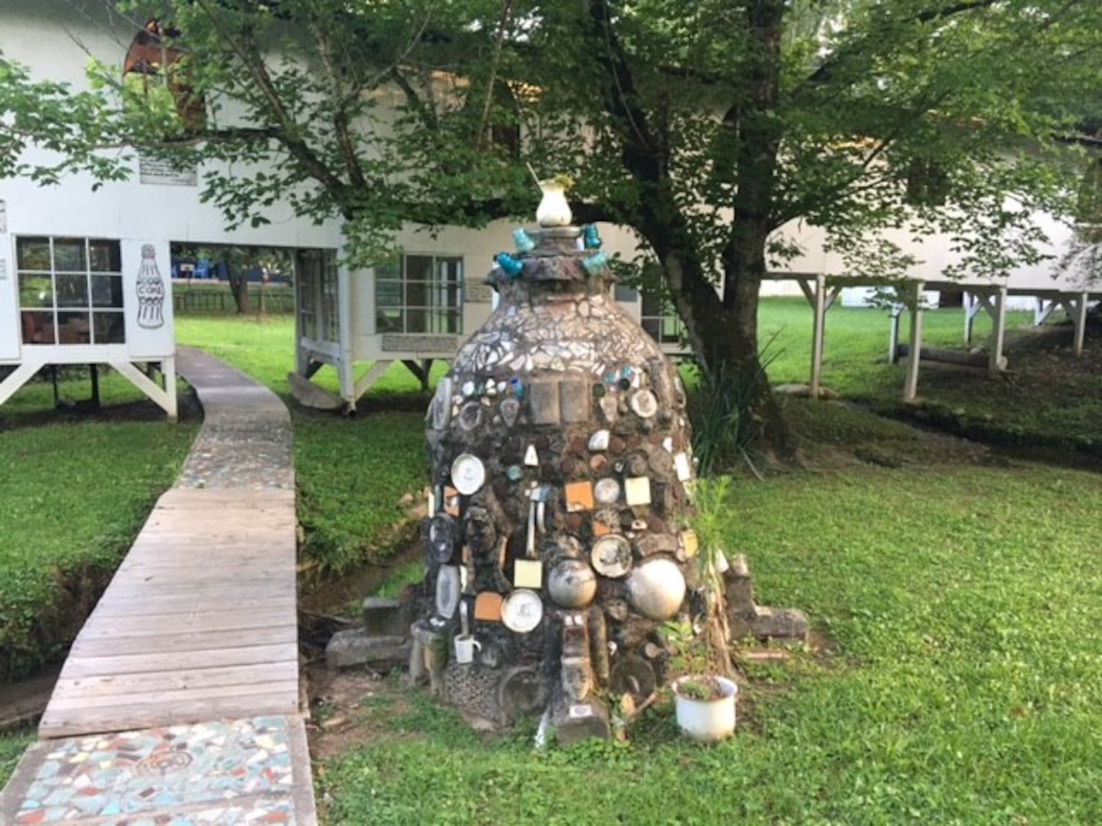 One of the many concrete mounds that folk artist Howard Finster placed around the grounds of Paradise Garden. He embedded them with all sorts of materials. (BILL RANKIN/william.rankin@ajc.com)