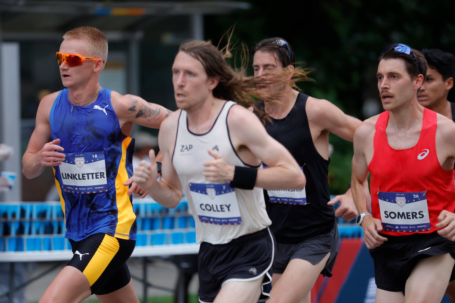 Elite men run along Peachtree Street during the 54th running of The Atlanta Journal-Constitution Peachtree Road Race in Atlanta on Tuesday, July 4th, 2023.   (Natrice Miller / Natrice.Miller@ajc.com)