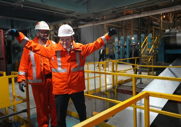 Canadian Prime Minister designate Mark Carney, front, tours the ArcelorMittal Dofasco steel plant in Hamilton, Ontario, on Wednesday, March 12, 2025. (Nathan Denette/The Canadian Press via AP)