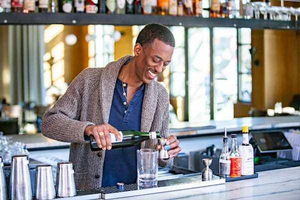 Navarro Carr, bar manager at Southern National, builds a Bitter Heart cocktail featuring gin, cynar and amaretto. (Ryan Fleisher for The Atlanta Journal-Constitution)  