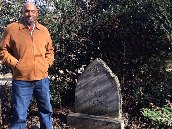 Nick Chubb's father, Henry, with the marker for the family chapel. (Steve Hummer/shummer@ajc.com