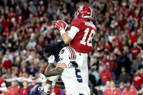 Alabama defensive back Bray Hubbard (18) intercepts a pass intended for Auburn wide receiver KeAndre Lambert-Smith (5) during the second half of an NCAA college football game, Saturday, Nov. 30, 2024, in Tuscaloosa, Ala. (AP Photo/Butch Dill)