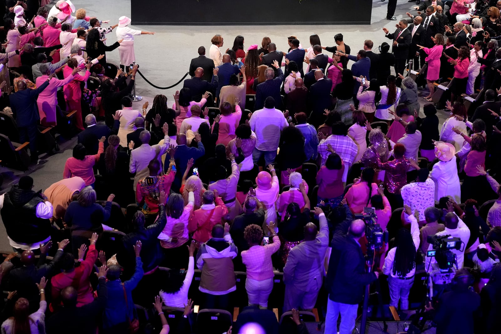 The congregation prays for Democratic presidential nominee Vice President Kamala Harris, top center, at a church service at New Birth Baptist Church in Stonecrest, Ga., Sunday, Oct. 20, 2024. (AP Photo/Jacquelyn Martin)