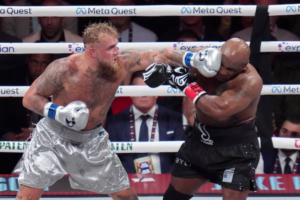 Jake Paul lands a left to Mike Tyson during their heavyweight boxing match, Friday, Nov. 15, 2024, in Arlington, Texas. (AP Photo/Julio Cortez)