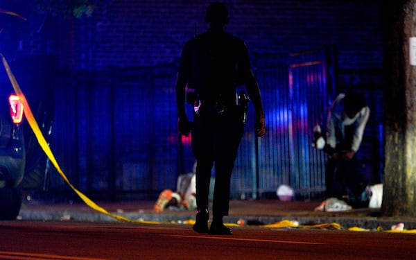 An Atlanta police officer checks a shooting scene on Martin Luther King Jr. Drive on Saturday, August 13, 2022. (Photo: Ben Hendren for The Atlanta Journal-Constitution)